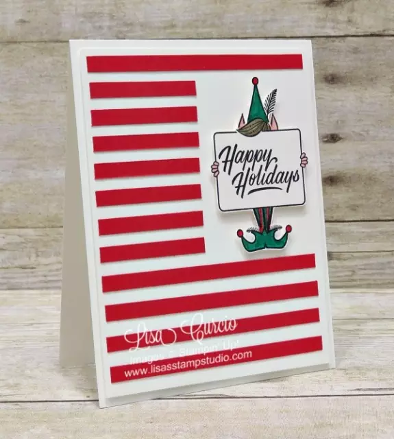 Angled view of a Christmas card using red cardstock stripes as a frame around a little elf. Stampin' Up!'s Festive Phrases.