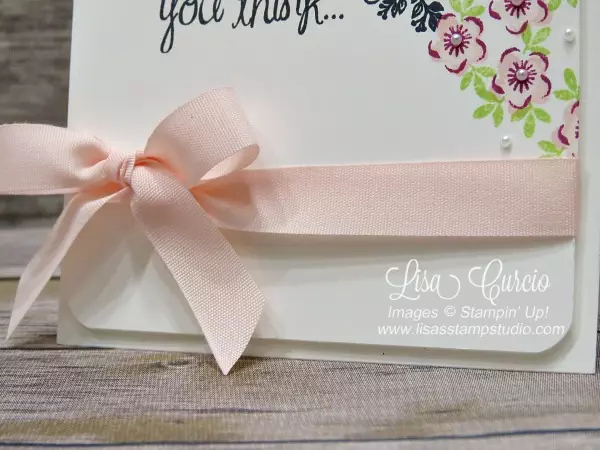 Close up view of a beautiful pink bow laid across a sympathy card with a script greeting surrounded by delicate flowers. Tranquil Tulips and Heartfelt Sympathy from Stampin' Up!